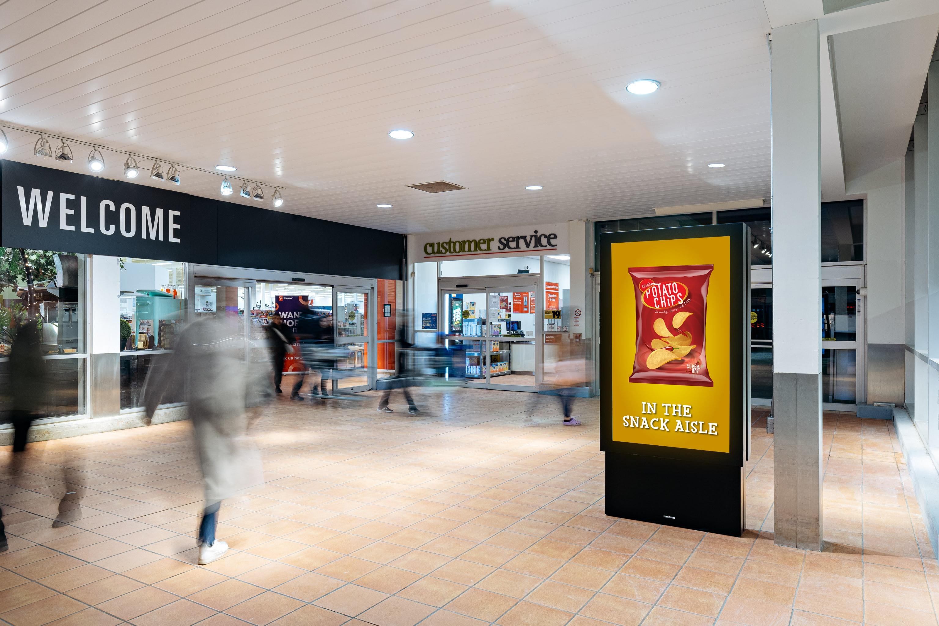 A digital screen next to a Zehrs grocery store that's advertising chips.